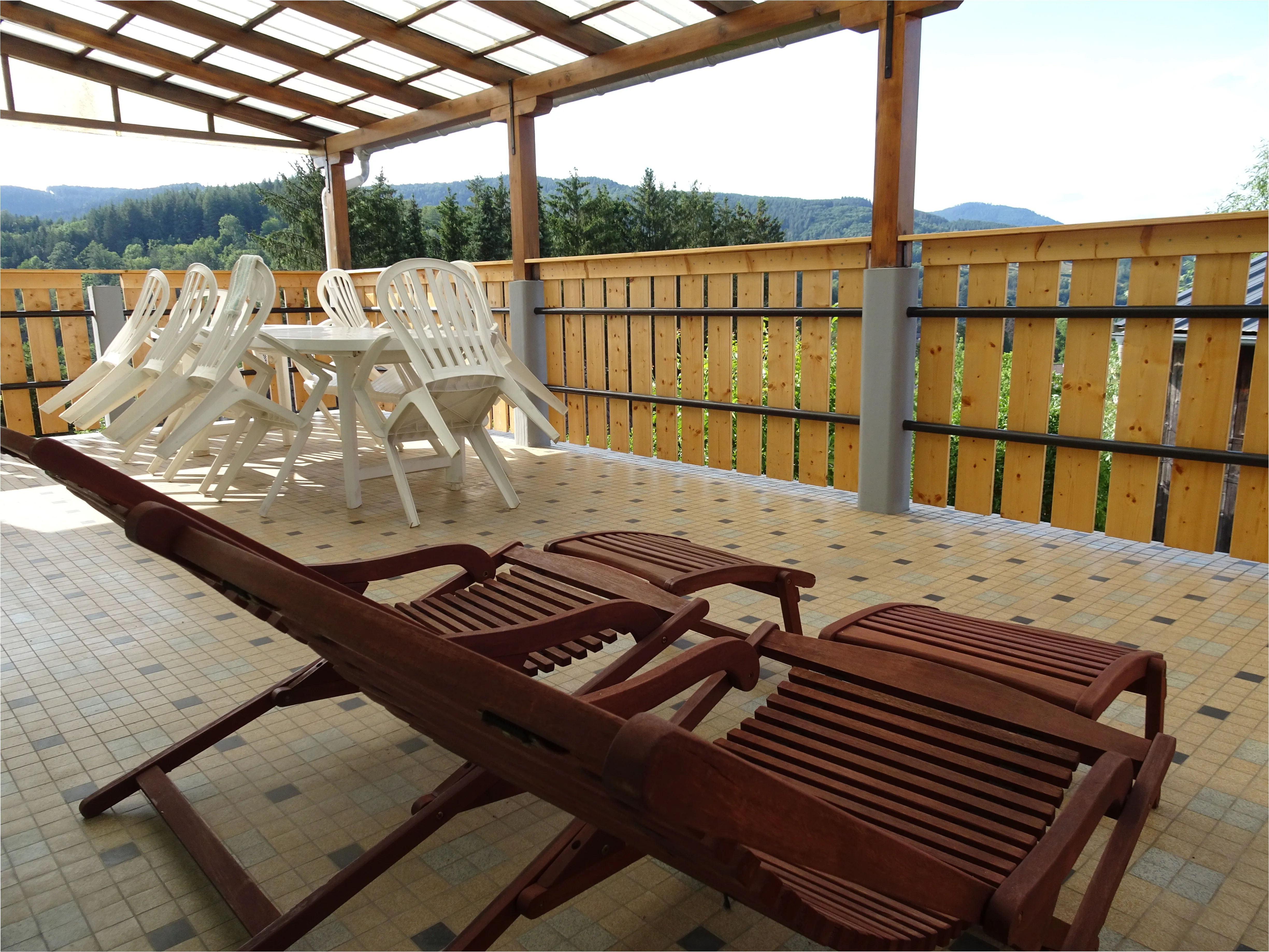 Terrace with garden furniture and deckchairs
